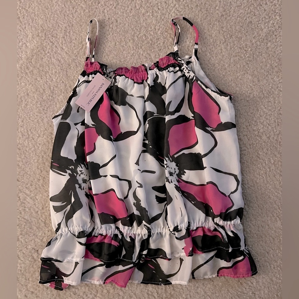 Flowy top with ruffled bottom. Pink, black and white. New with tag.
